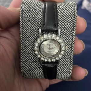 Black and Silver Watch with Round Face and Sparkling Bezel